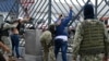 Soldiers frisk two men suspected of belonging to a criminal gang remain detained during a joint operation between the Ecuadorean National Police and members of the armed forces to prevent violent acts, in Guayaquil, Ecuador, on Jan.15, 2024.