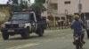 Motoqueiro e carro da polícia
