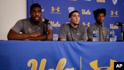 UCLA basketball player Cody Riley, left, reads his statement as he is joined by teammates LiAngelo Ball, center, and Jalen Hill during a news conference at UCLA, Nov. 15, 2017, in Los Angeles. 