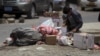 A boy searches for food amongst litter in Sanaa, April 8, 2015.