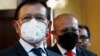 Cambodia National Rescue Party's President Kem Sokha, left, speaks to journalists before heading to the court in his house in Phnom Penh, Cambodia, Wednesday, Jan. 19, 2022. (AP Photo/Heng Sinith)
