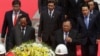 Laos President Bounnhang Vorachith, foreground right, walks together with Cambodian Defense Minister Tea Banh, foreground left, during a ceremony to pay respects at the Monument Independence in Phnom Penh, Cambodia, Wednesday, Feb. 22, 2017. (AP Photo/Heng Sinith)