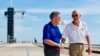 In this Tuesday, July 16, 2019 photo made available by NASA, astronaut Michael Collins, right, speaks to Kennedy Space Center Director Bob Cabana at Launch Complex 39A, about the moments leading up to launch at 9:32 a.m. on July 16, 1969, and what it was 
