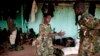 FILE - A May 2012 photo shows a young South Sudanese soldier who appeared to be drunk reaching for a lighter for his cigarette at the Sudan People's Liberation Army (SPLA) headquarters in Bentiu, Unity State.