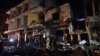 FILE - People gather in the aftermath of a multiple explosive attack in the Sayyida Zeinab area, 10 kilometers south of Damascus, Syria, Feb. 21, 2016. The Islamic State group claimed responsibility for a triple blast in the Shi'ite suburb.