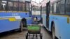 FILE - A porter sits in his pushcart as he waits for customers in between passenger buses at a municipal bus terminal in Bengaluru, India, Sept. 8, 2015. The first bus of its kind hit the streets of the Indian capital, New Delhi, Wednesday equipped with safety features to increase security for women.