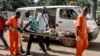 A wounded man is being carried into the General Hospital in Bangui on Sept. 26, 2015, after unknown assailants opened fire in the PK5 district, a neighborhood with a majority of Muslim residents.