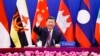 In this photo released by Xinhua News Agency, Chinese President Xi Jinping waves as he chairs the ASEAN-China Special Summit to commemorate the 30th Anniversary of ASEAN-China Dialogue Relations via video link from Beijing, China on Monday, Nov. 22, 2021.