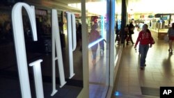 Shoppers walk by the GAP store, file photo. 