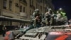 FILE - Members of the Wagner Group military company sit atop of a tank on a street in Rostov-on-Don, Russia, June 24, 2023.