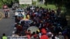 Migrants walk along the road in a caravan in an attempt to reach the U.S border, in Tapachula, Mexico Nov. 5, 2023. 