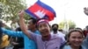 Rong Chhun, an environment activist, waves a Cambodian national flag after being released from the Correctional center in Phnom Penh, Cambodia, on November 12, 2021. (LICADHO/Raksmey Sok Handout via REUTERS)