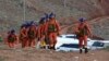 FILE - Rescuers walk into the accident site where 21 cross-country ultramarathon runners died near Baiyin, Gansu province, China, May 23, 2021. (Xinhua News Agency via AP)