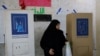 An Iraqi woman visits a polling station to cast her vote, during Iraq's provincial council elections, in Baghdad, Iraq, Dec. 18, 2023. 