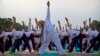 Prime Minister Narendra Modi performs yoga along with thousands of Indians on Rajpath in New Delhi, June 21, 2015.