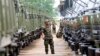FILE PHOTO - A Cambodian army soldier looks at Chinese military vehicles displayed before a handover ceremony at a military airbase in Phnom Penh, Cambodia, Wednesday, June 23, 2010. 