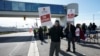 FILE Unifor worker Claude Robitaille holds a sign at GM's Oshawa assembly complex on Oct. 10, 2023. The Canadian union announced early Oct. 30, 2023, it would commence strikes at Stellanis facilities in the country.