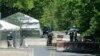 FILE - Security officials stand at a checkpoint outside of Camp Round Meadow, on the closed road leading up to the presidential retreat of Camp David, in Thurmont, Maryland, May 18, 2012. 