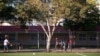 FILE - Youths play basketball at Currie Park in Minneapolis, near a large Somali community in the Cedar Riverside neighborhood, where the director of tadvocacy center says he's seen recruiters for terrorist groups approach kids in the park.