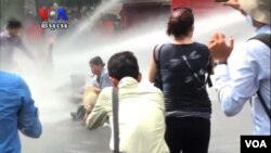 Land dispute protesters hit by water canon as they tried to block a main street in Phnom Penh, May 29, 2013.