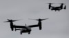 FILE — U.S. Marine Corps V-22 Osprey aircraft approach John F. Kennedy International Airport in New York, Sept. 25, 2014. A V-22 Osprey crashed off western Japan during training last week. Remains of six of the eight crew members aboard the aircraft have been recovered so far.