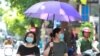 Women wearing face masks walk on the street in Hanoi, Vietnam, Thursday, July 30, 2020. Vietnam on Thursday reported several more cases of COVID-19, as the first outbreak in over three months spread to cities while authorities say they cannot trace…
