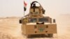 FILE - Iraqi government forces drive their armored vehicle, June 22, 2016, some 40 kilometers (25 miles) west of Qayyarah, during their operation to take the city and make it a launchpad for Mosul. 