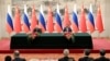 Президент России Владимир Путин и Председатель КНР Си Цзиньпин принимают участие в церемонии подписания соглашения по итогам своих переговоров в Пекине 16 мая 2024 года.