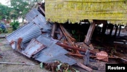A damaged house is seen after a tsunami hit the Venga village on Solomon Islands, February 7, 2013. 
