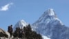 FILE - Trekkers make their way to Dingboche, a popular Mount Everest base camp, in Pangboche, Nepal, Feb. 19, 2016. Officials say three foreign climbers along with three Nepalese guides have scaled Mount Everest, the first foreigners to reach the summit in two years.