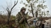 A Ukrainian serviceman inspects a RPG-7 shell at a former Russian position outside the village of Robotyne, amid Russia's attack on Ukraine, near a front line in Zaporizhzhia region, Ukraine Nov. 4, 2023.