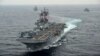 FILE - The amphibious assault ship USS Boxer transits the East Sea during an exercise, March 8, 2016. The Boxer Amphibious Readiness Group has been sent to waters off the coast of Yemen.