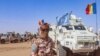 FILE - A Chadian soldier with the United Nations Multidimensional Integrated Stabilization Mission in Mali (MINUSMA) stands in front of a convoy outside the city of Gao in Mali on Oct. 25, 2023.