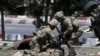 FILE - U.S. soldiers attend to a wounded soldier at the site of a blast in Kabul, Afghanistan June 30, 2015. 