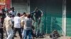 Activists of the Bangladesh Nationalist Party attack security officers during a protest in Dhaka, Bangladesh, Oct. 28, 2023. Police in Bangladesh's capital fired tear gas to disperse supporters of the main opposition party who threw stones at security officials.