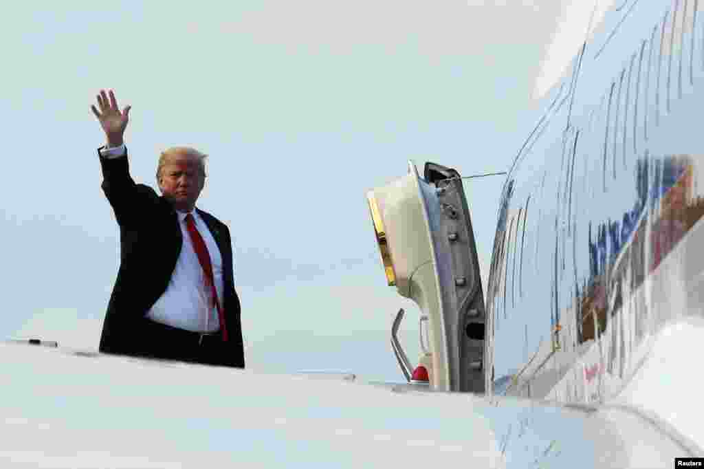 U.S. President Donald Trump waves as he boards Air Force One after his summit with North Korean leader Kim Jong Un in Singapore