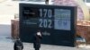 A man stands in front of a countdown clock for Tokyo Olympic and Paralympic Games in Tokyo, Wednesday, Feb. 3, 2021. Pressure is building on Japanese organizers and the IOC to explain exactly how they plan to hold the Tokyo Olympics in the midst of…
