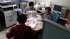 North Korean defectors, working for FreeNK newspaper in South Korea, wrap editions of paper in plastic, ready for the air drop. (Photo: Jason Godman / VOA) 