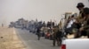 Shi'ite paramilitaries riding military vehicles travel from Lake Tharthar toward Ramadi to fight against Islamic state militants, west of Samarra, Iraq, May 27, 2015.