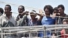 FILE - Migrants wait to be disembarked from the Irish Navy ship P31 L.E. Eithne at the Catania harbor, Italy, June 16, 2015. 