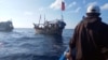 A boat carries Rohingya people stranded at sea, Indonesia, December 27, 2021, in this still image obtained from a social media video.