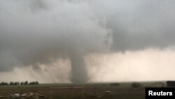 A tornado spins during stormy weather in Mangum, Okla., May 20, 2019. 