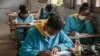 Une bouteille de Covid Organics devant un élève du lycée J.J. Rabearivelo, dans le centre d'Antananarivo, le 23 avril 2020. (Photo: RIJASOLO / AFP)
