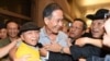 Dissident Vietnamese blogger Nguyen Van Hai, center, greets supporters at Los Angeles International Airport in California on Oct. 21, 2014.