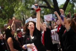 FILE - Women celebrate after registering the Feminist Alternative Party (PAF) in the Electoral Service and starting the legal process to become a political party, at the Electoral Service office in Santiago, Chile, Jan. 28, 2020.