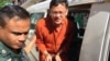 Ny Chakrya, National Election Committee officer, was escorted by the security officers to the appeal court on November 28, 2016, Phnom Penh, Cambodia. (Kann Vicheika/VOA Khmer)