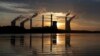  In this June, 3, 2017, file photo, the sun sets behind Georgia Power's coal-fired Plant Scherer, one of the nation's top carbon dioxide emitters, in Juliette, Ga. (AP Photo/Branden Camp, File)