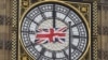 A British Union flag flutters in front of one of the clock faces of the 'Big Ben' clocktower of The Houses of Parliament in central London, Feb. 22 , 2016