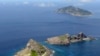 FILE - A group of disputed islands, Uotsuri island (top), Minamikojima (bottom) and Kitakojima, known as Senkaku in Japan and Diaoyu in China is seen in the East China Sea, in this photo taken by Kyodo Sept. 2012. 