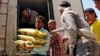 A Yemeni volunteer carries bags of rice to displaced people, who fled fighting in the southern city of Aden, during a food distribution effort in Taiz, Yemen, May 9, 2015.